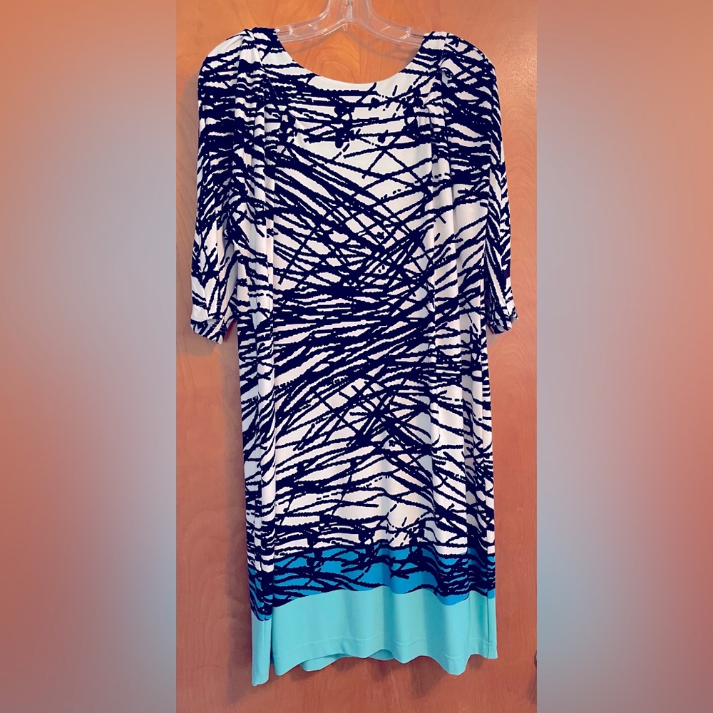 White & black dress with a strip of blue and turquoise along the bottom.